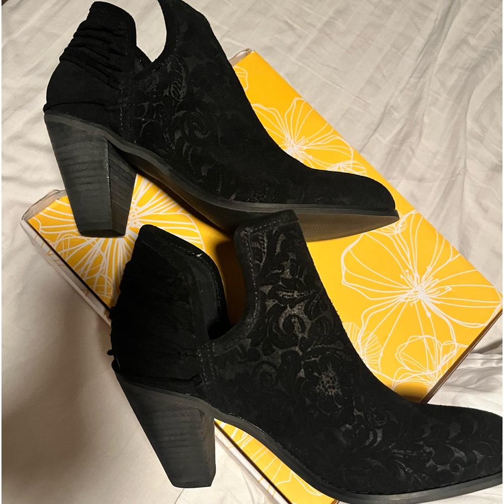 Woman’s black suede ankle boot